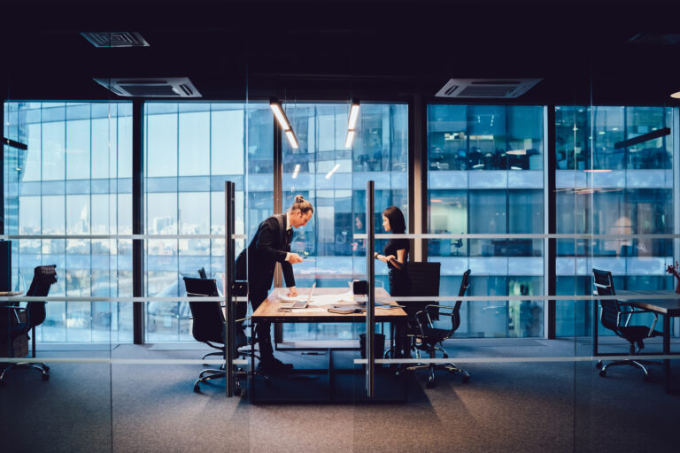 Male and female employees talking to each other discussing ideas and planning on architectural project, 30s skilled woman and man business partners having productive cooperation in office